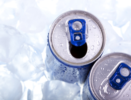 Tops of soda cans in ice