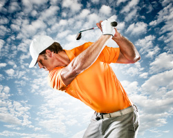 Dramatic image of a man golfing